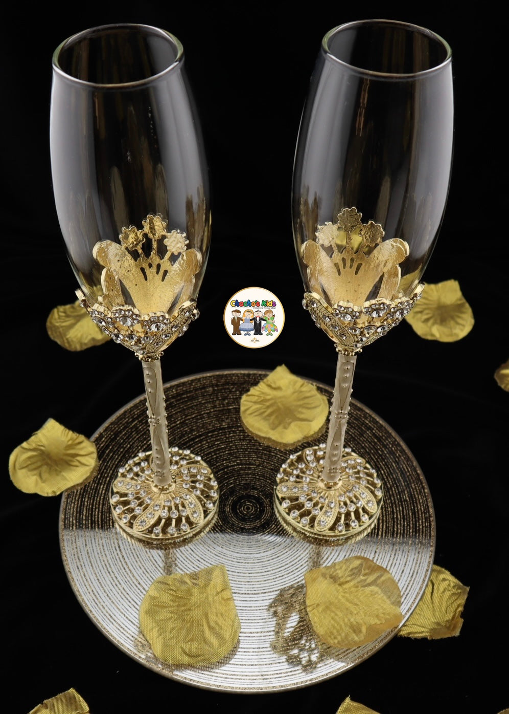Two decorative Wedding wine glasses with gold crowns on a black background