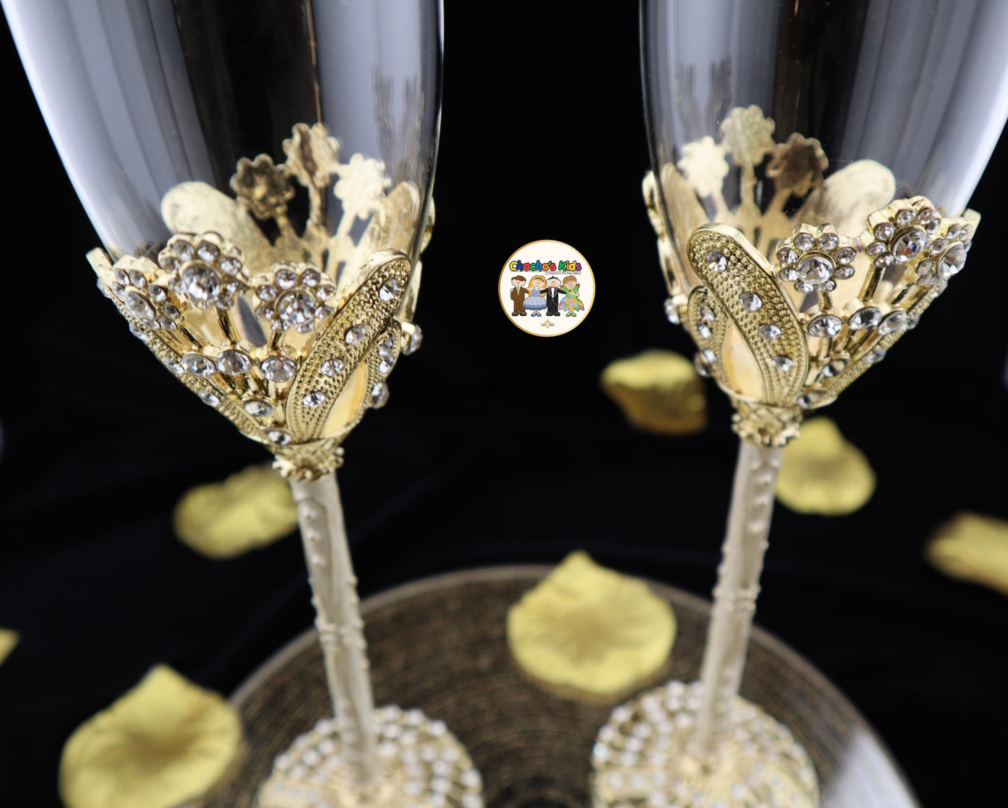 Decorative Wedding champagne flutes with gold embellishments on a dark background