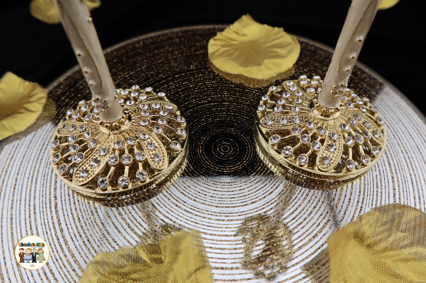 Decorative Wedding Flutes with gold and black designs on a textured surface
