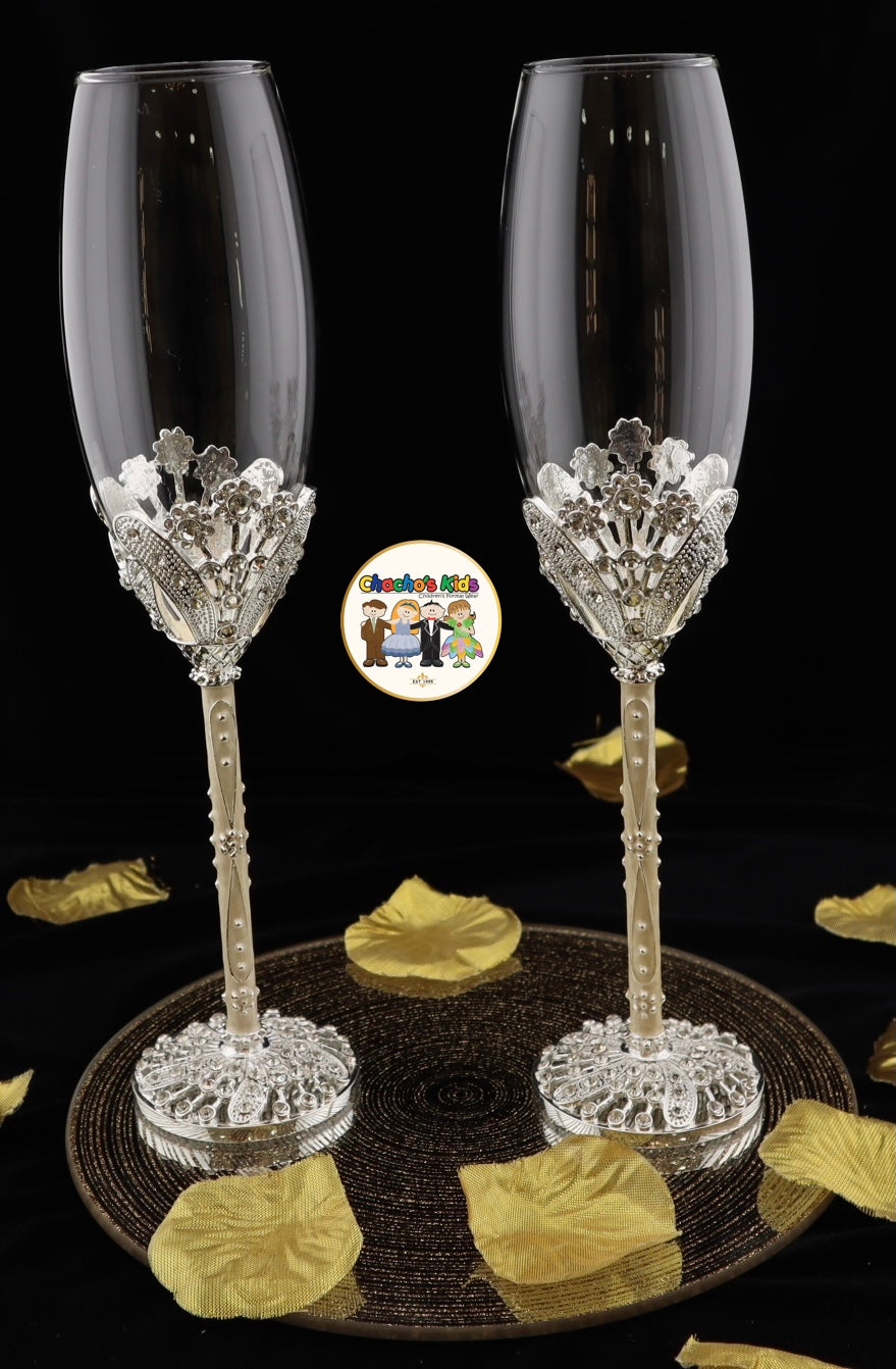 Two decorative Wedding champagne flutes with intricate designs on a black background.