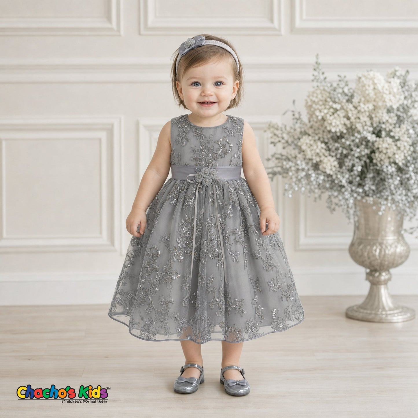 Baby girl wearing silver embroidered sequin flower girl dress with floral waist detail, style 1597