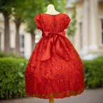 Red embroidered flower girl dress detail with floral bodice and full skirt