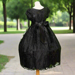 Black embroidered flower girl dress detail with floral bodice and full skirt