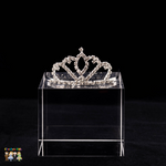A silver sparkling crystal princess hair comb tiara displayed on a clear stand against a black background.