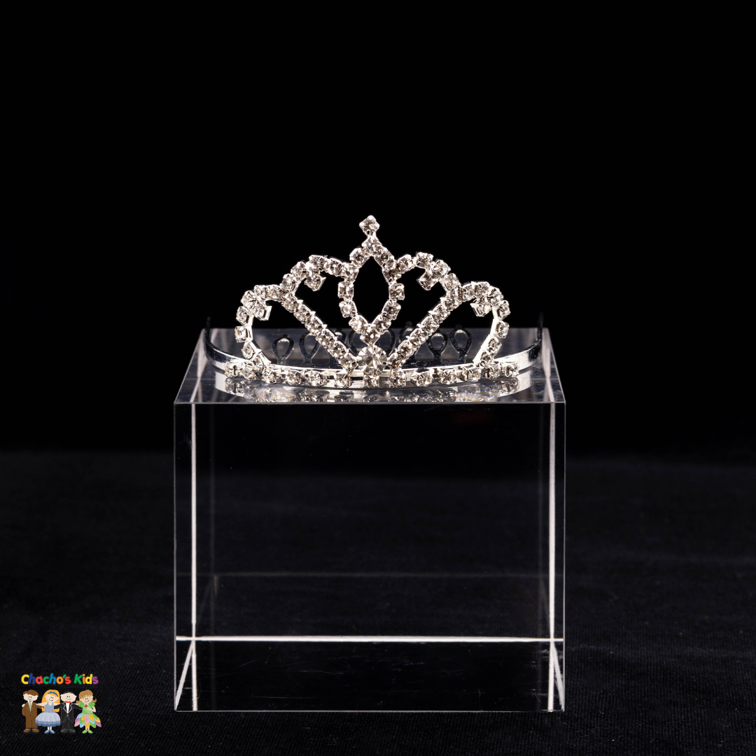 A silver sparkling crystal princess hair comb tiara displayed on a clear stand against a black background.