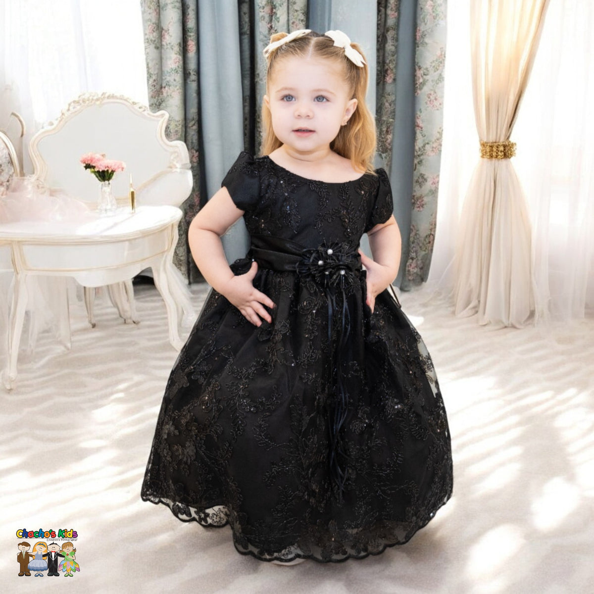 Embroidered flower girl dress showing full tulle skirt, floral details and satin waistband