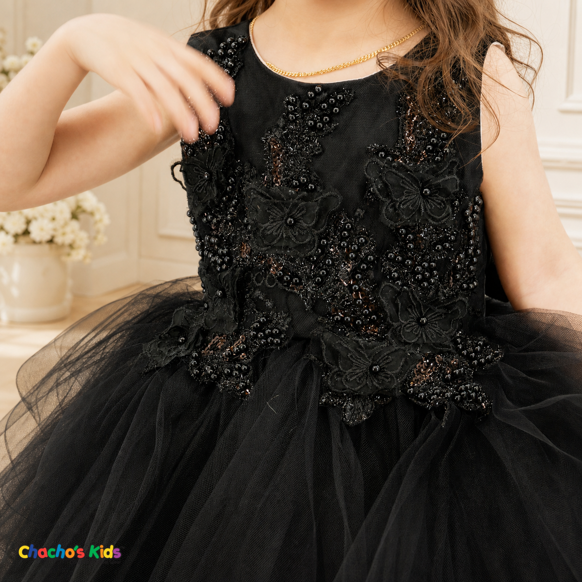Close-up of black 9149B baby flower girl dress with butterfly appliqués, pearls and sequins