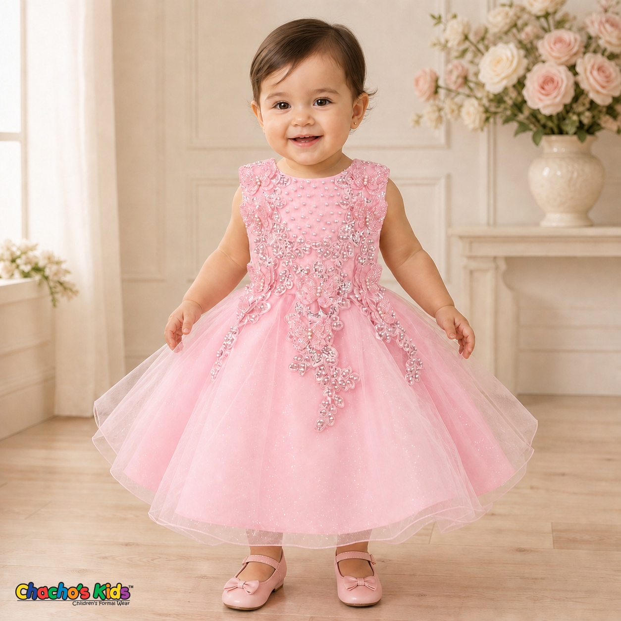 Pink baby flower girl dress 9156B with butterfly embroidery, pearl details, layered glitter tulle skirt, and no head accessory on a realistic toddler model