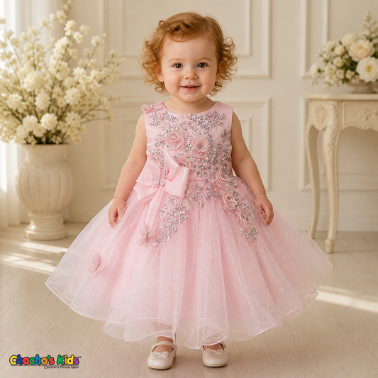 Pink baby flower girl dress 9166B with silver sequin floral embroidery, butterfly details, side bow, and layered glitter tulle skirt on a toddler model