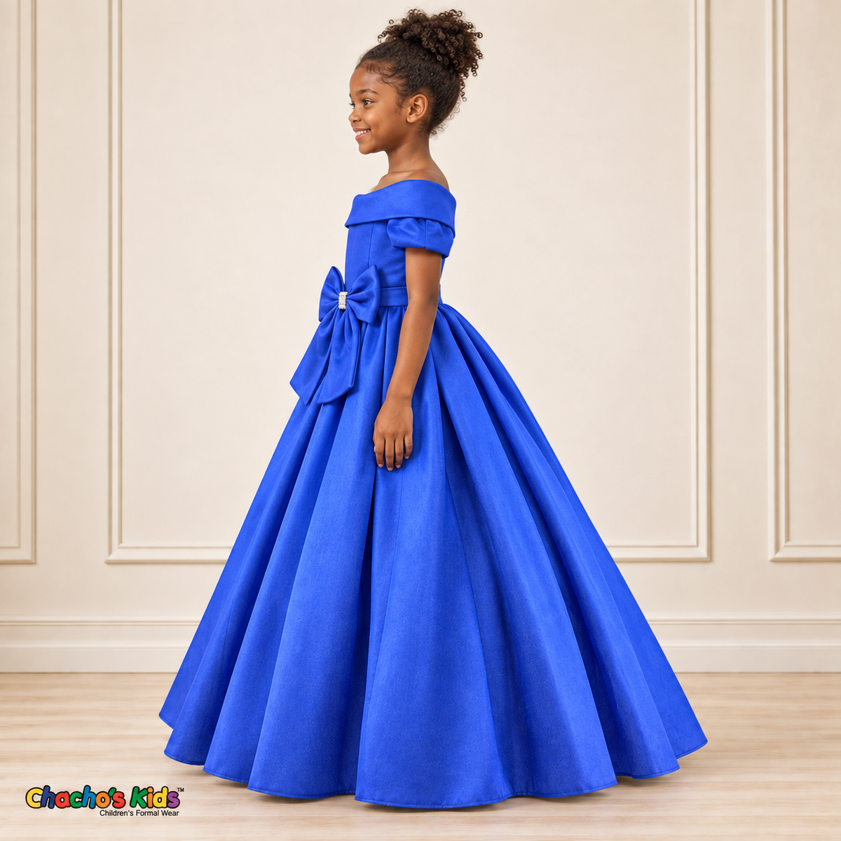 Royal Blue ball gown dress, style 9177, left-facing side view on a child model with a folded neckline, jeweled waist bow and full floor-length skirt.
