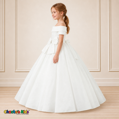 White ball gown dress, style 9177, left-facing side view on a child model with a folded neckline, jeweled waist bow and full floor-length skirt.