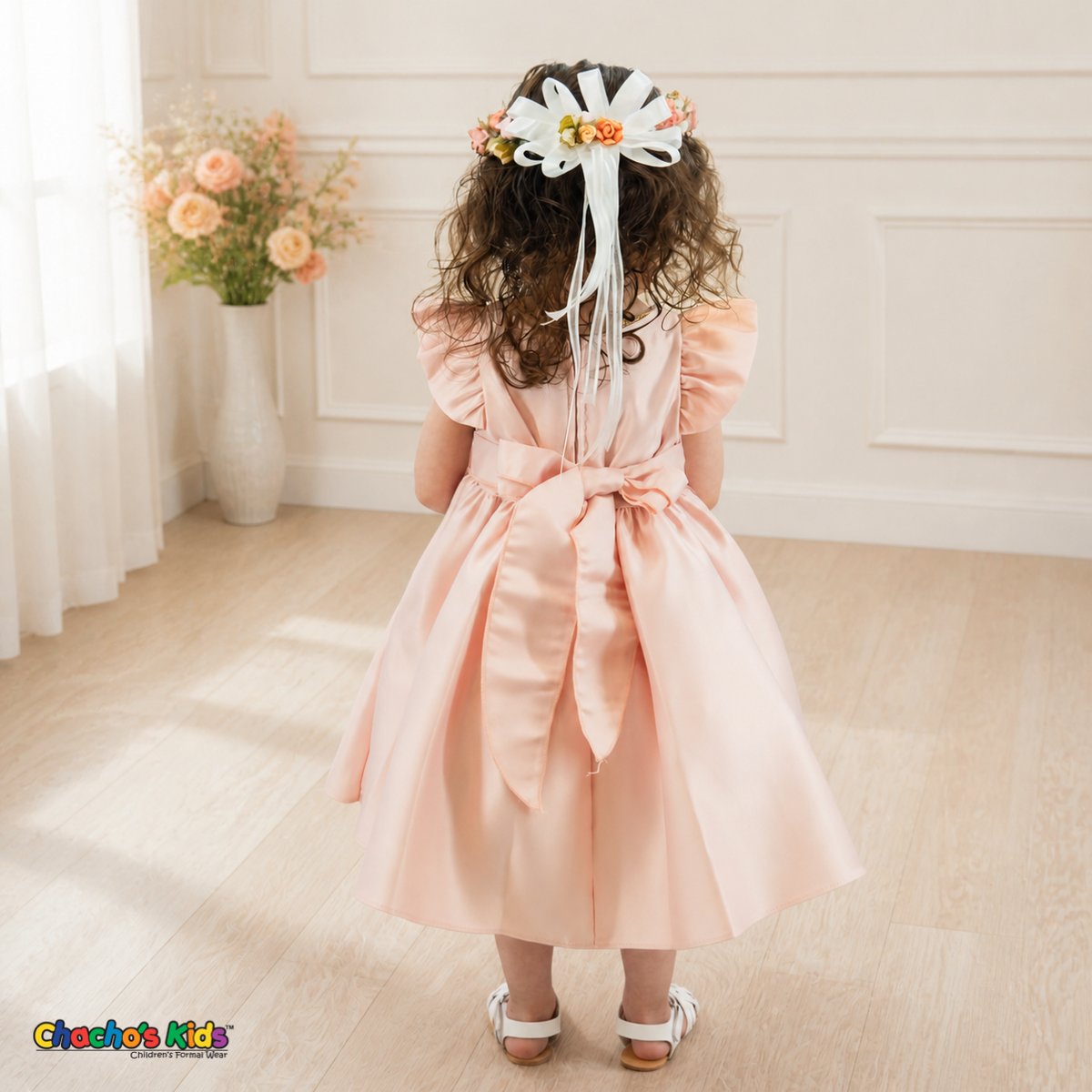 Back view of blush B263 baby satin dress with sash bow and floral crown ribbons