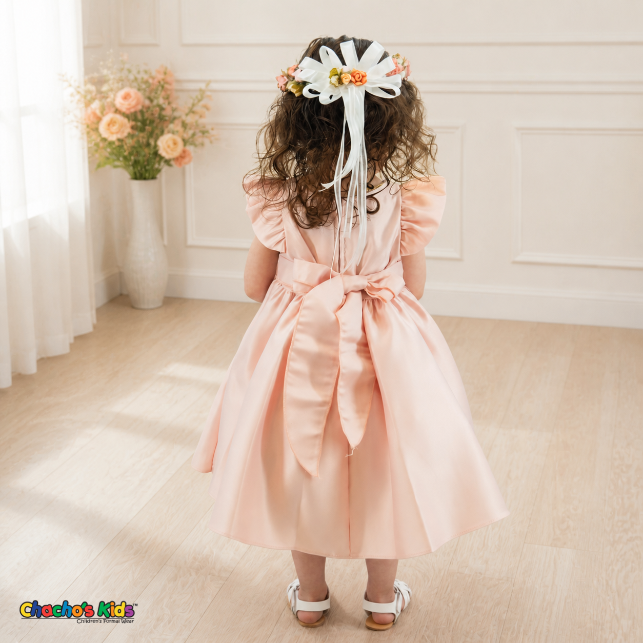 Back view of blush B263 baby satin dress with sash bow and floral crown ribbons