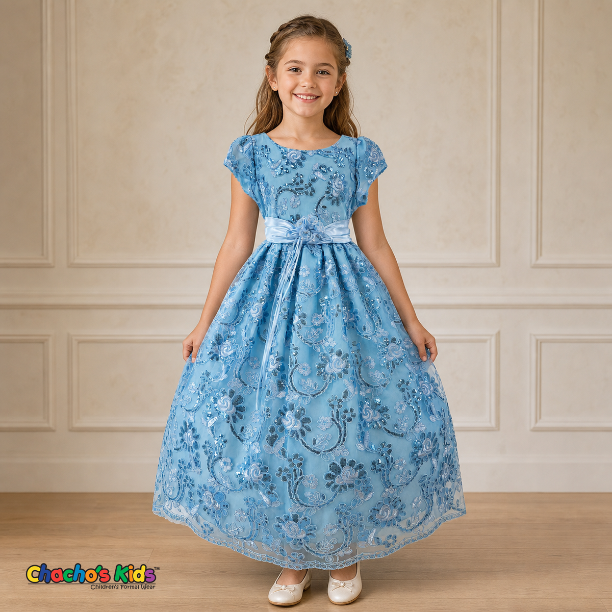 Girl wearing baby blue embroidered flower girl dress with satin bow, cap sleeves and full tulle skirt