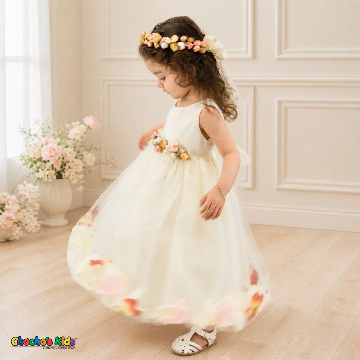 Side twirl view of ivory D1095 baby flower girl dress with floral waist and petal-filled tulle skirt