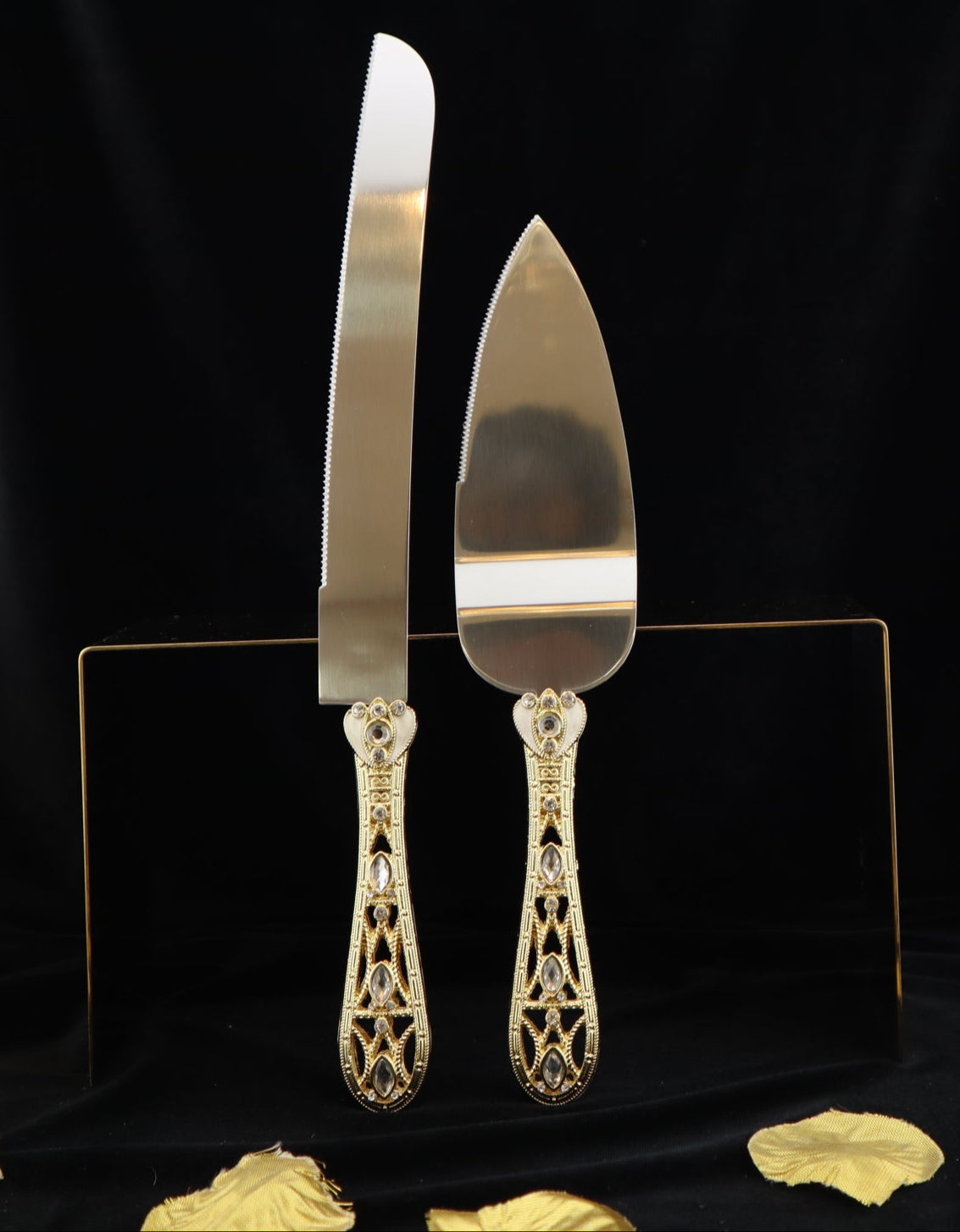 Gold cake server set on a black background