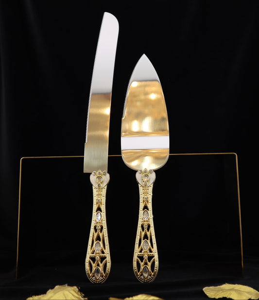 Gold cake server and knife set on a black background