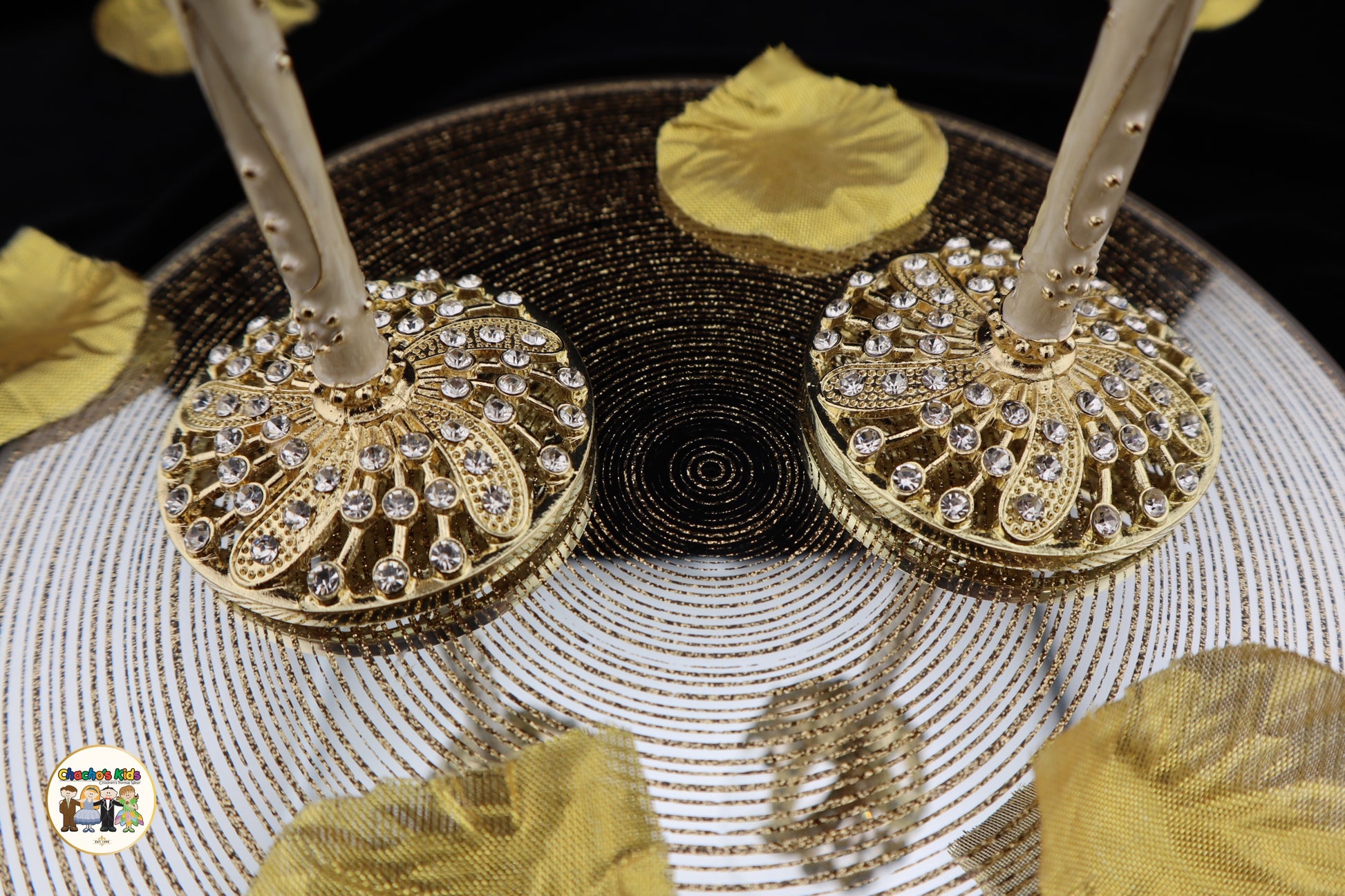 Decorative Wedding Flutes with gold and black designs on a textured surface