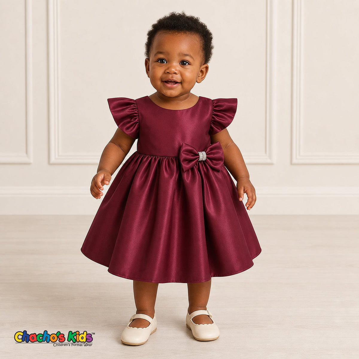 Baby girl wearing burgundy satin flower girl dress with flutter sleeves and bow, style B263