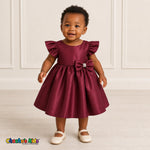 Baby girl wearing burgundy satin flower girl dress with flutter sleeves and bow, style B263