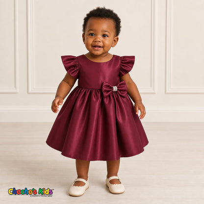 Baby girl wearing burgundy satin flower girl dress with flutter sleeves and bow, style B263