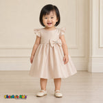 Baby girl wearing champagne satin flower girl dress with flutter sleeves and bow, style B263