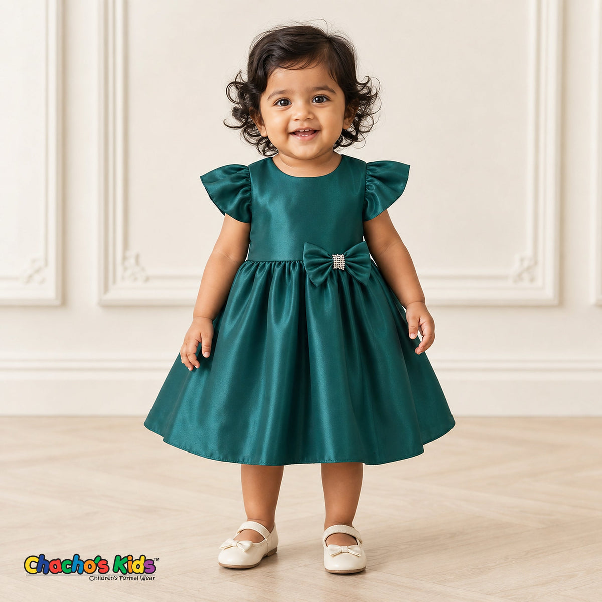 Baby girl wearing emerald green satin flower girl dress with flutter sleeves and bow, style B263