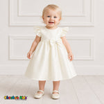 Baby girl wearing ivory satin flower girl dress with flutter sleeves and bow, style B263