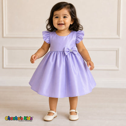 Baby girl wearing lilac satin flower girl dress with flutter sleeves and bow, style B263