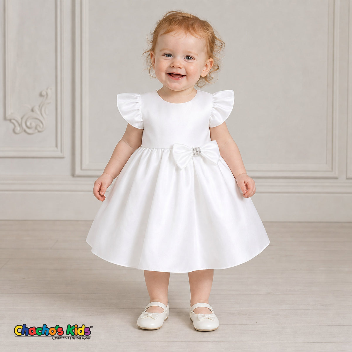 Baby girl wearing white satin flower girl dress with flutter sleeves and bow, style B263