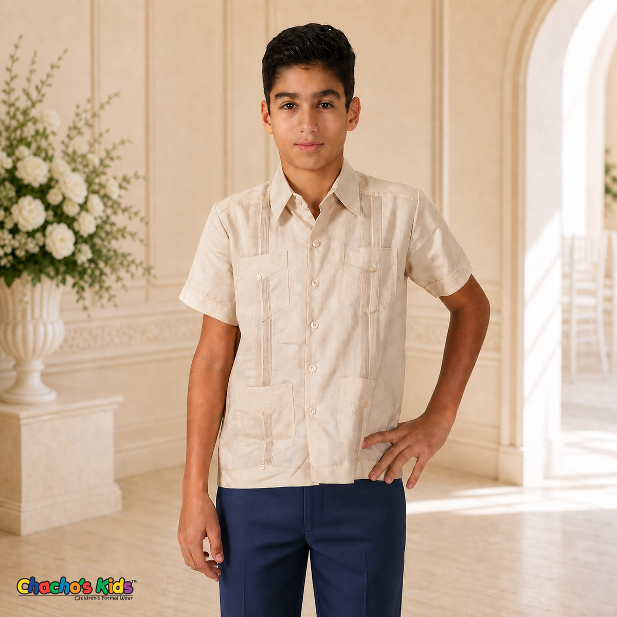 Real boy model wearing champagne 100% linen classic guayabera with four pockets and navy dress trousers