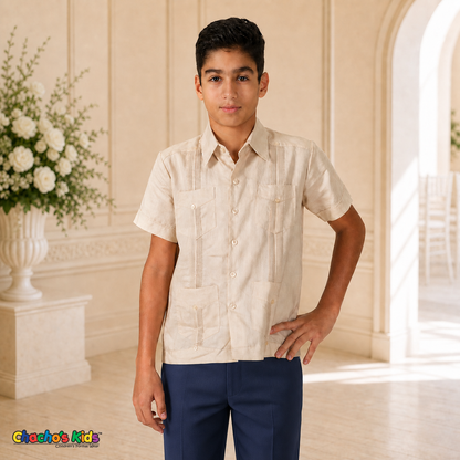 Real boy model wearing champagne 100% linen classic guayabera with four pockets and navy dress trousers