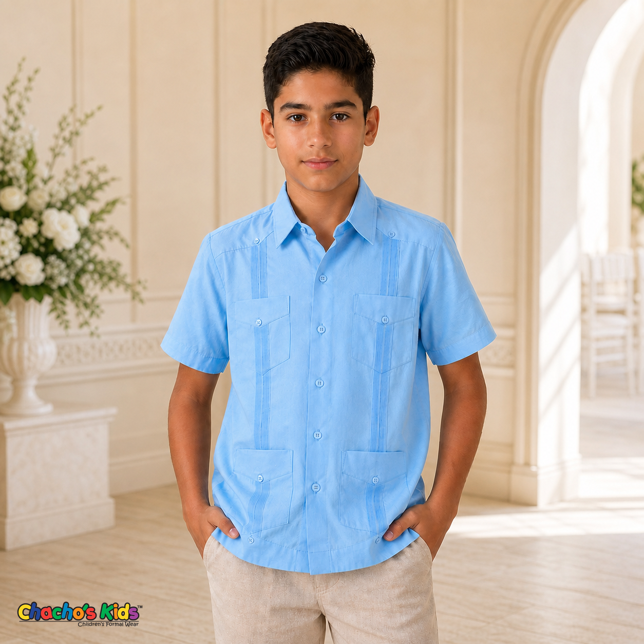 Real boy model wearing light blue 100% linen classic guayabera with four pockets and pintuck panels at a formal event