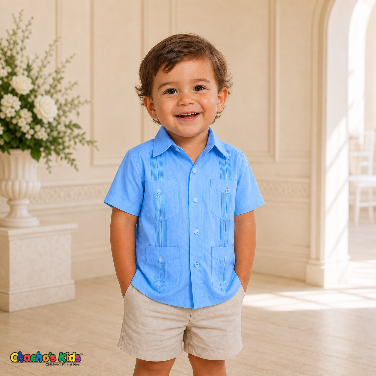 Toddler boy wearing light blue 100% linen classic guayabera with four pockets at a formal celebration