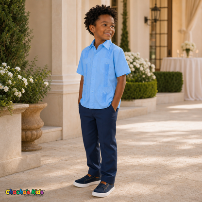 Young boy wearing light blue 100% linen classic guayabera with four pockets, three-quarter formal view