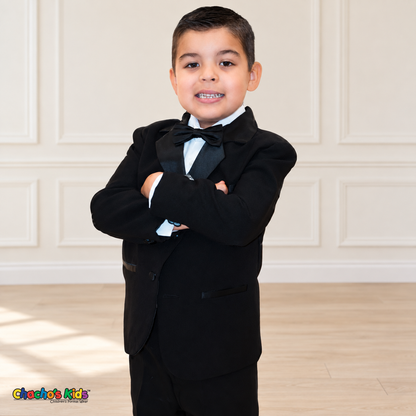 Boys Signature Tuxedo in Black (BY010), child model arms-crossed portrait showing black tuxedo fabric and satin lapels.