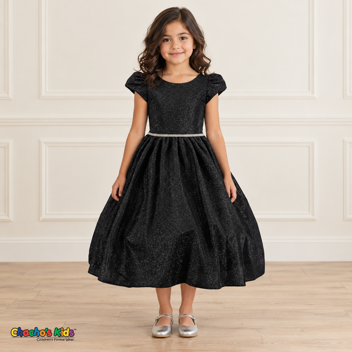 Front view of a girl wearing the black shimmer puff sleeve party dress, Style 444, with a jeweled waist and full gathered skirt.
