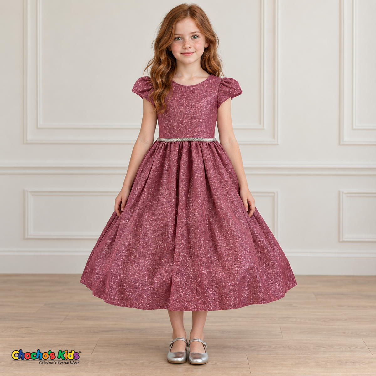 Front view of a girl wearing the dusty rose shimmer puff sleeve party dress, Style 444, with a jeweled waist and full gathered skirt.