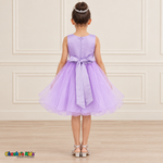Back view of the lilac Style 9150 tulle dress on a girl, showing the zipper, matching satin bow, and layered curled hem.