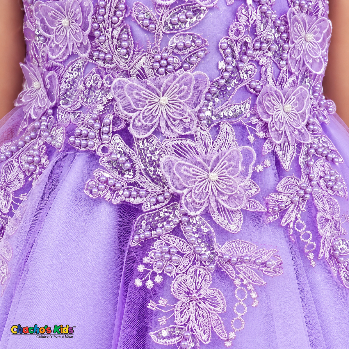 Close-up of the lilac Style 9150 butterfly appliqués and pearl-beaded embroidery cascading onto glitter tulle.