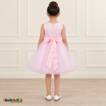 Back view of the pink Style 9150 tulle dress on a girl, showing the zipper, matching satin bow, and layered curled hem.