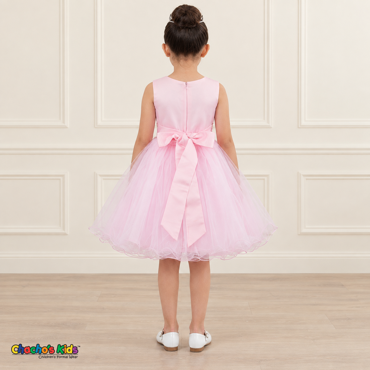 Back view of the pink Style 9150 tulle dress on a girl, showing the zipper, matching satin bow, and layered curled hem.