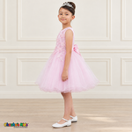 Side view of a girl wearing the pink Style 9150 butterfly embroidered dress with a full layered tulle skirt.