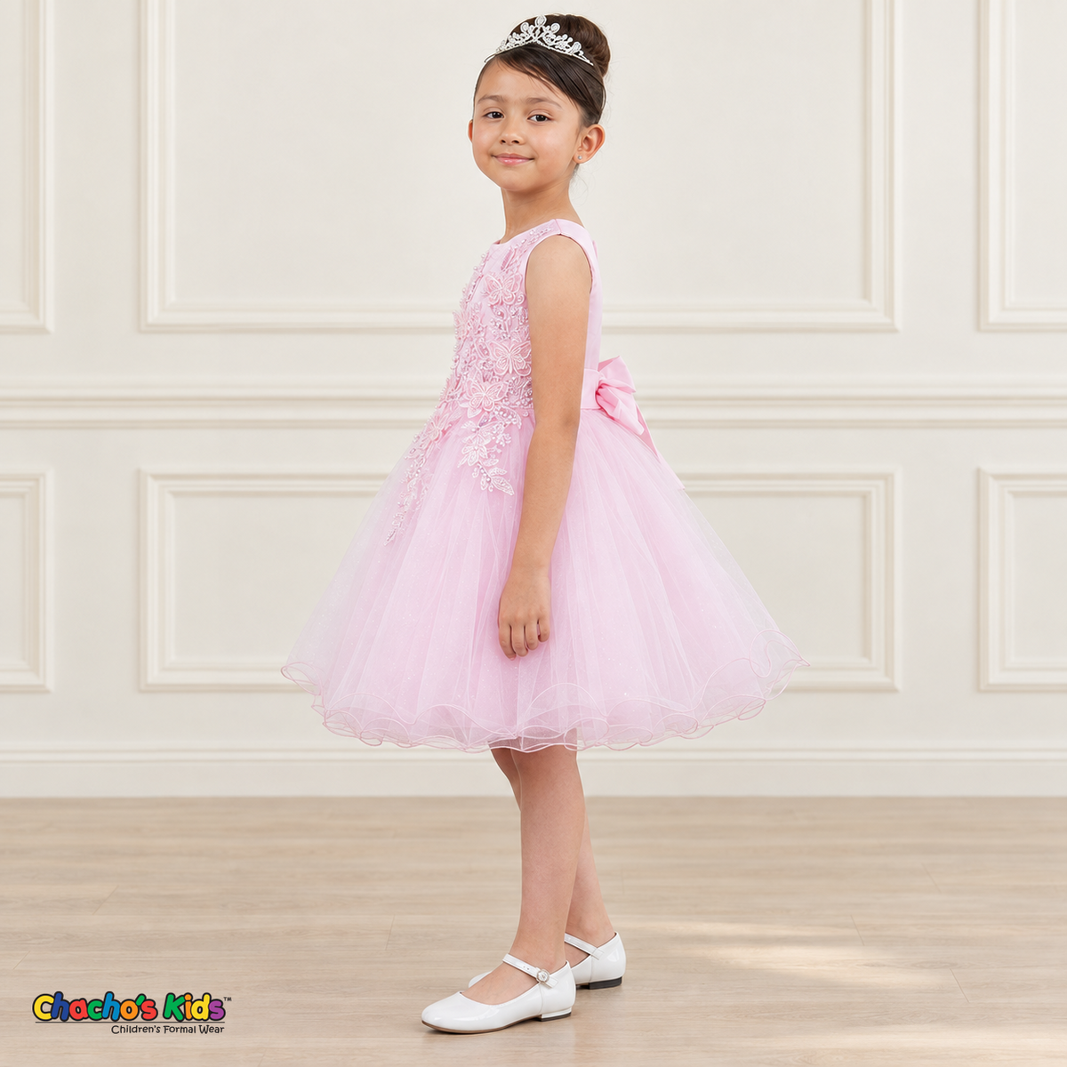 Side view of a girl wearing the pink Style 9150 butterfly embroidered dress with a full layered tulle skirt.