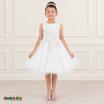 Front view of a girl wearing the white Style 9150 butterfly embroidered tulle dress with pearl accents and a curled hem.