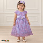 Baby girl wearing the Lilac Baby Floral Rosette Dress D-1664, front view with matching bow headband.