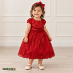 Baby girl wearing the Red Baby Floral Rosette Dress D-1664, three-quarter front view.