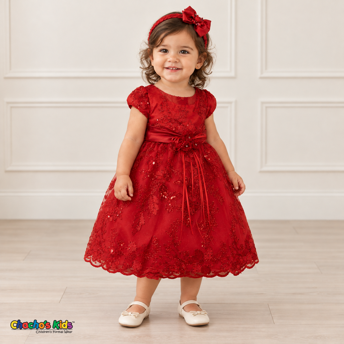 Baby girl wearing the Red Baby Floral Rosette Dress D-1664, three-quarter front view.