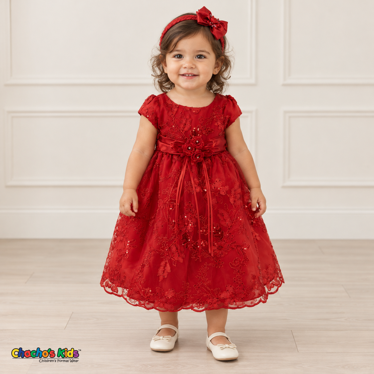 Baby girl wearing the Red Baby Floral Rosette Dress D-1664, front view with matching bow headband.