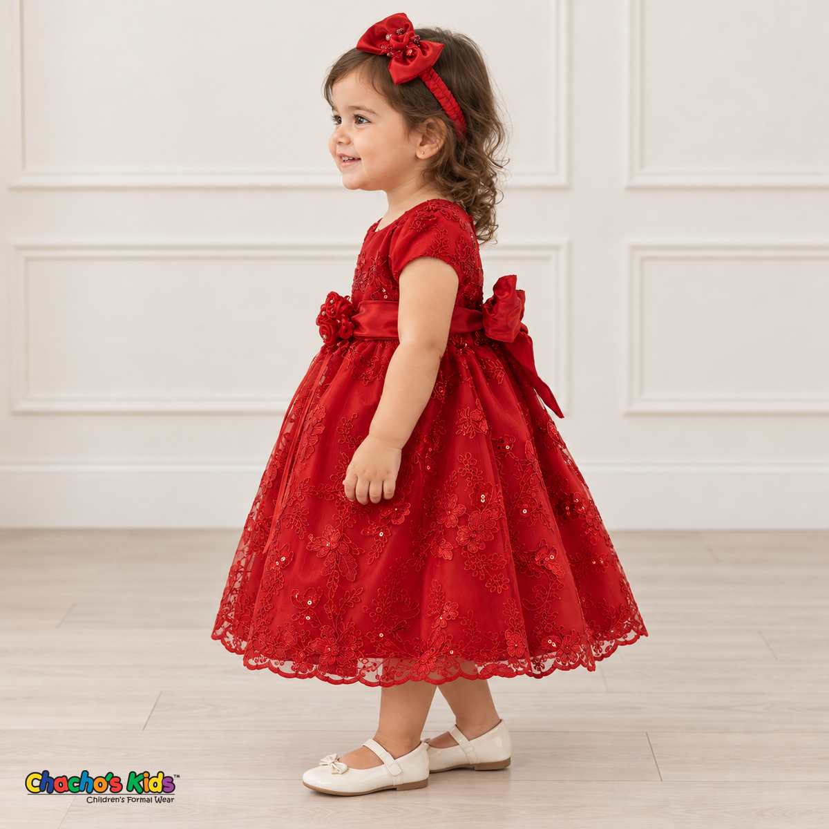Baby girl wearing the Red Baby Floral Rosette Dress D-1664, left side view.